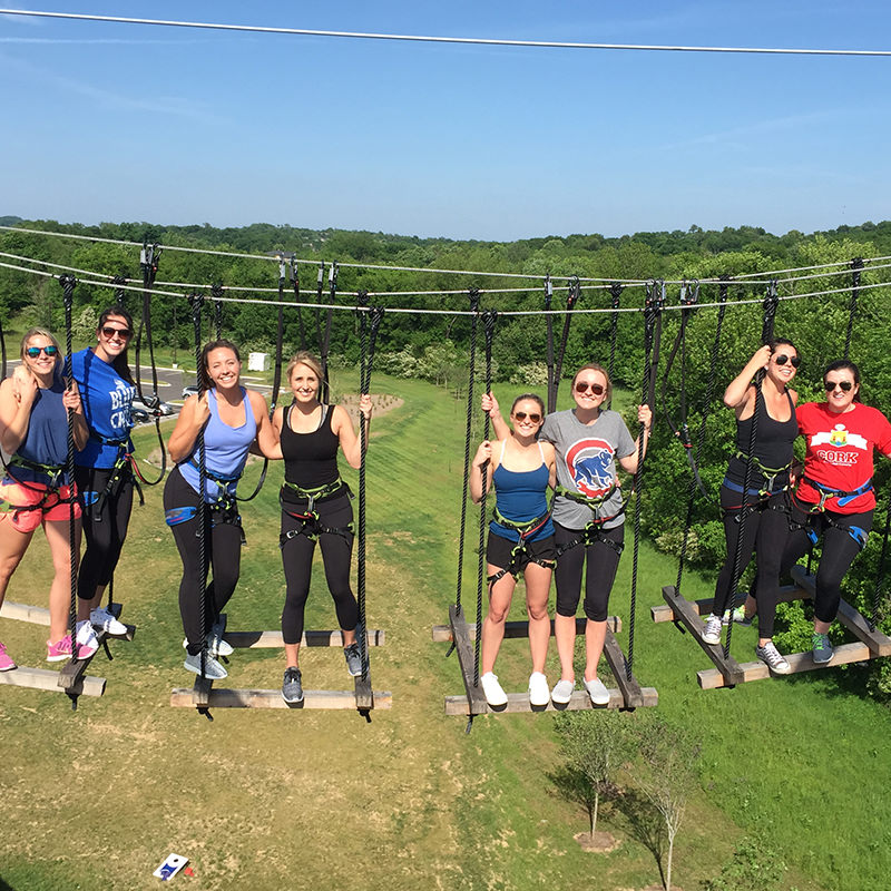 Girls standing up high half way on the sky bridge